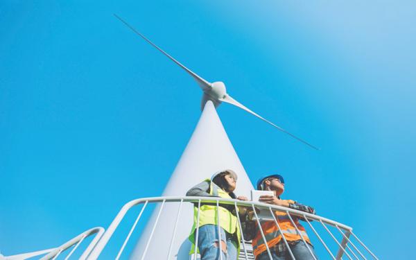 Maintenance engineers working on wind turbine in windfarm stock photo - Credit: iStock - 827003060