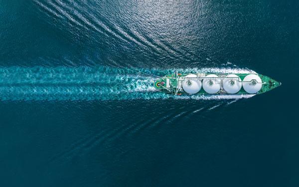 Aerial top view LNG Tanker ship (Liquified Natural Gas) with contrail in the ocean sea ship carrying container and running for export from container international port to custom ocean concept freight shipping by ship service stock photo.CREDIT_istock-1661