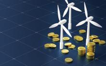 Renewable Energy Investment Concept with Wind Turbines and Coins.credit_istock-2178302769