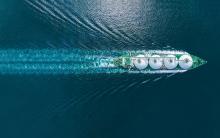 Aerial top view LNG Tanker ship (Liquified Natural Gas) with contrail in the ocean sea ship carrying container and running for export from container international port to custom ocean concept freight shipping by ship service stock photo.CREDIT_istock-1661