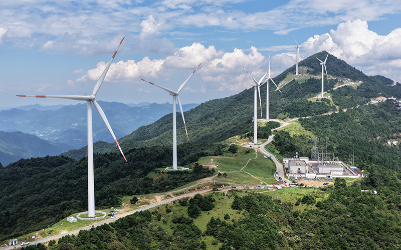 Wind turbines in China’s mountains. China achieved its 2030 wind and solar capacity targets six years ahead of schedule. CREDIT_Shutterstock-2679259541