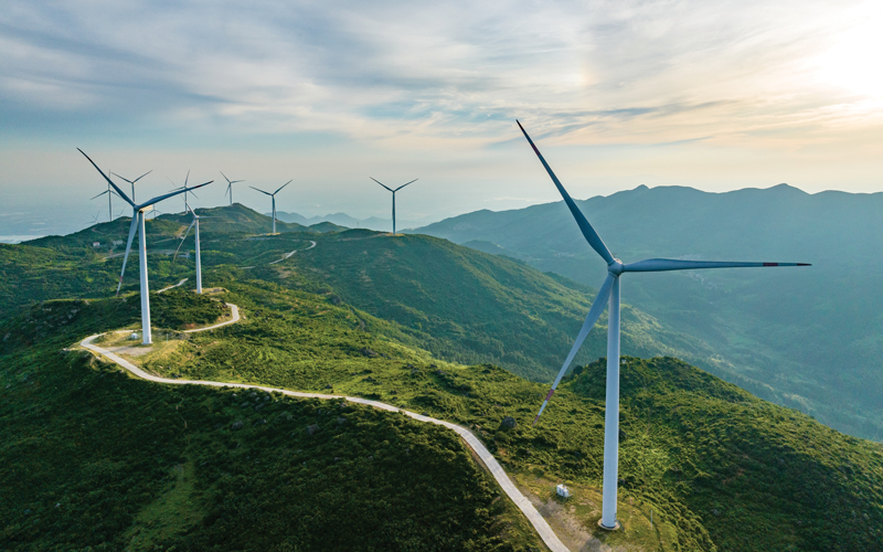 Wind farm on the mountain, blue sky and white clouds.shutterstock_2337580197
