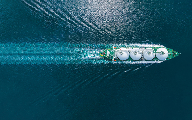 Aerial top view LNG Tanker ship (Liquified Natural Gas) with contrail in the ocean sea ship carrying container and running for export from container international port to custom ocean concept freight shipping by ship service stock photo.CREDIT_istock-1661